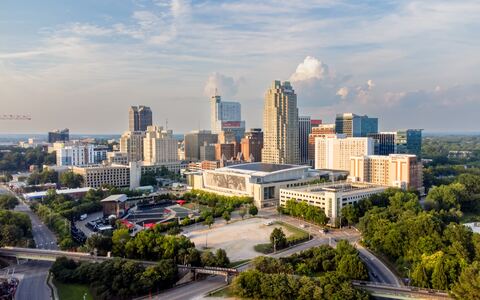 Archival Raleigh skyline photograph used as the video poster.